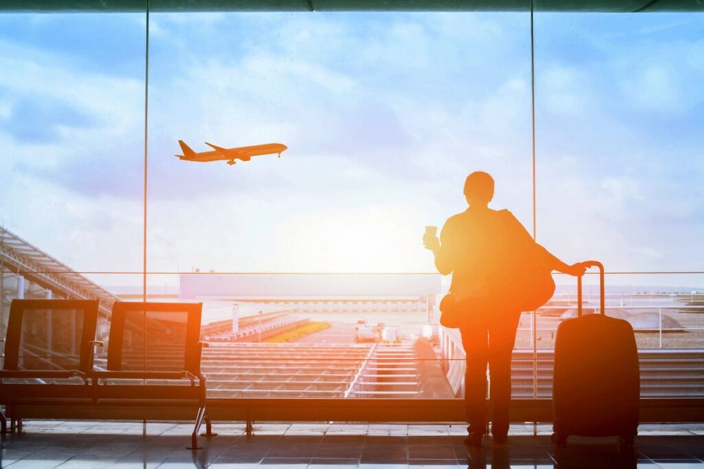 Airport window with a plane taking off