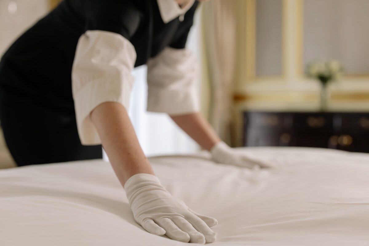 housekeeper making bed