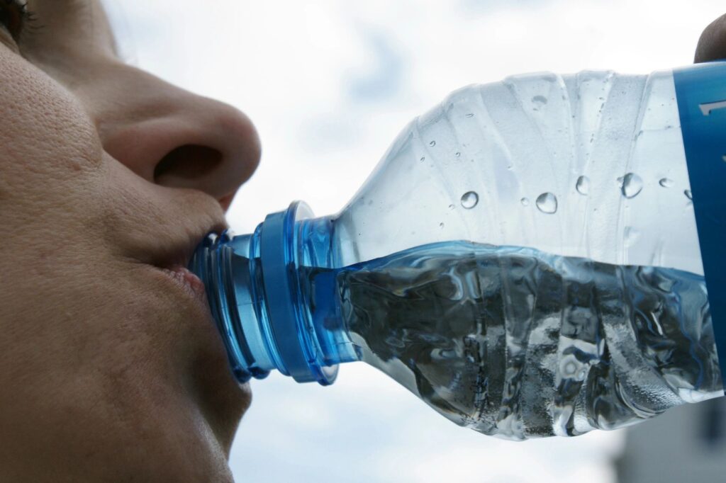 woman drinking bottled water